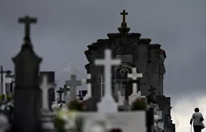 Woman walks along tombs at the municipal cemetery of San Salvador in Oviedo Woman walks along tombs at the municipal cemetery of San Salvador in Oviedo