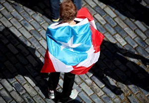 A woman is wrapped in a national flag during a protest demanding that authorities fix the A woman is wrapped in a national flag during a protest demanding that authorities fix the