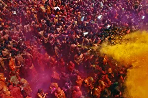 Women cover themselves as men pour coloured water on them during Huranga at Dauji Women cover themselves as men pour coloured water on them during Huranga at Dauji