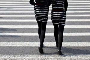 Women walk on a pedestrian cross in central Shanghai Women walk on a pedestrian cross in central Shanghai