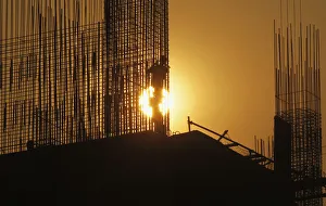 A worker arranges steel structures at construction site of apartment in Hanoi A worker arranges steel structures at construction site of apartment in Hanoi