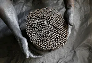 A worker covers firecrackers with gunpowder in a makeshift fireworks factory ahead of New A worker covers firecrackers with gunpowder in a makeshift fireworks factory ahead of New
