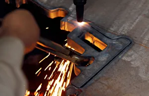 A worker cuts the frame of a handgun out of a sheet of steel at the Peshawar Arms Company A worker cuts the frame of a handgun out of a sheet of steel at the Peshawar Arms Company