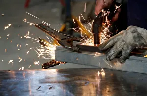 A worker welds a piece of metal at a steel workshop in Marseille A worker welds a piece of metal at a steel workshop in Marseille