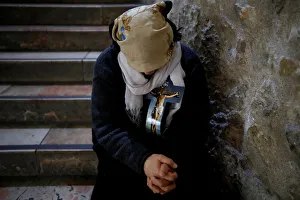 A worshipper rests in the Church of the Holy Sepulchre during a Good Friday procession A worshipper rests in the Church of the Holy Sepulchre during a Good Friday procession