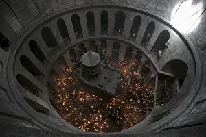 Worshippers hold candles during the Christian Orthodox Holy Fire ceremony at the Church Worshippers hold candles during the Christian Orthodox Holy Fire ceremony at the Church