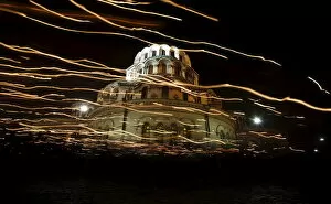 Images Dated 11th April 2015: Worshippers walk with candles around the golden-domed Alexander Nevski cathedral during