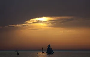 Yachts are silhouetted as sun sets over Lake Constance in Bregenz Yachts are silhouetted as sun sets over Lake Constance in Bregenz