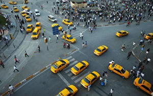 Images Dated 19th June 2013: Yellow taxis pass people standing in silence during a protest at Taksim Square