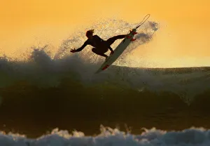 Young surfer sails his board off a wave as large swells hit the California coastline Young surfer sails his board off a wave as large swells hit the California coastline