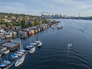 Aerial view of sailboats and houseboats on Lake Union with downtown Seattle in the Aerial view of sailboats and houseboats on Lake Union with downtown Seattle in the