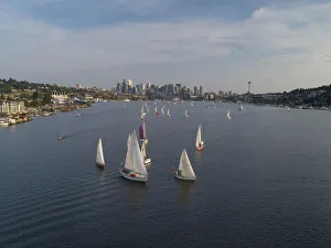Aerial view of sailboats racing on Lake Union in the evening with the Seattle skyline in Aerial view of sailboats racing on Lake Union in the evening with the Seattle skyline in
