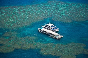 Aerial view of a tour boat docked at a pontoon at the Great Barrier Reef, Queensland Aerial view of a tour boat docked at a pontoon at the Great Barrier Reef, Queensland
