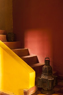 Africa, Morocco. An old lantern and jug on steps of a restored Kasbah with a texture Africa, Morocco. An old lantern and jug on steps of a restored Kasbah with a texture