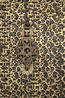 Africa, Morocco. A detail of an ornate brass door and fancy door knocker Africa, Morocco. A detail of an ornate brass door and fancy door knocker