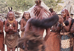 Clapping Gallery: Africa, Namibia, Opuwo. Himba woman in motion during a dance