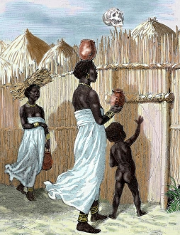 Africa. Two women and a child entering in the village Africa. Two women and a child entering in the village