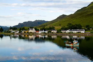 Beautiful photo of small village of Dornie with refections and boat in Western Highlands Beautiful photo of small village of Dornie with refections and boat in Western Highlands