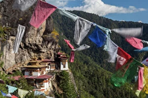 Spiritual Collection: Bhutan, Paro. Prayer flags fluttering at the cliffs edge across from Taktsang Monastery