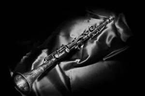 Light Painting Gallery: A black and white still life image of a brass clarinet