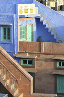 Blue City, Jodhpur, India. Blue apartment with a teal, green door, and painted flower pots Blue City, Jodhpur, India. Blue apartment with a teal, green door, and painted flower pots