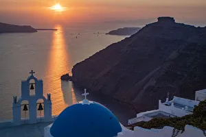 Blue dome church and famous three bells with cross and steeple in Fira, Santorini, Greece Blue dome church and famous three bells with cross and steeple in Fira, Santorini, Greece