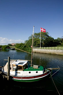Boat tied up at wharf on Ribe River, Ribe, Jutland, Denmark Boat tied up at wharf on Ribe River, Ribe, Jutland, Denmark