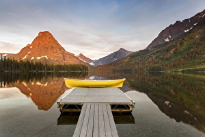 Boats on calm morning at Two Medicine Lake in Glacier National Park, Montana, USA Boats on calm morning at Two Medicine Lake in Glacier National Park, Montana, USA