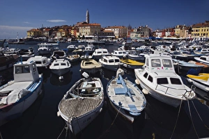 Boats docked in harbor in front of distant Cathedral of St. Euphemia, Rovigno, Croatia Boats docked in harbor in front of distant Cathedral of St. Euphemia, Rovigno, Croatia