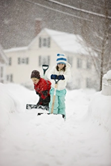 A brother and sister shovel snow during a snowstorm in Portsmouth, New Hampshire A brother and sister shovel snow during a snowstorm in Portsmouth, New Hampshire