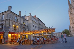 A cafe on the place pey berland in Bordeaux, outside seating terrasse lit by electric lights A cafe on the place pey berland in Bordeaux, outside seating terrasse lit by electric lights