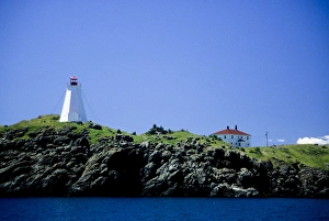 Canada: New Brunswick, Grand Manan, Swallowtail Light on granite cliff, July Canada: New Brunswick, Grand Manan, Swallowtail Light on granite cliff, July