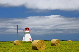 Canada, Prince Edward Island, Darnley. Lighthouse and farm bales Canada, Prince Edward Island, Darnley. Lighthouse and farm bales