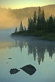 Canada, Quebec, Chibougamau. Lake in fog at sunrise. Credit as Canada, Quebec, Chibougamau. Lake in fog at sunrise. Credit as