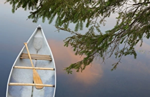 Canada, Quebec, Eastman. Canoe on lake at sunset Canada, Quebec, Eastman. Canoe on lake at sunset