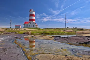 Canada, Quebec. Pointe-des-Monts lighthouse along Gulf of St. Lawrence Canada, Quebec. Pointe-des-Monts lighthouse along Gulf of St. Lawrence