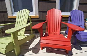 Canada St Martins New Brunswick colorful home with colorful Adirondack chairs on porch Canada St Martins New Brunswick colorful home with colorful Adirondack chairs on porch