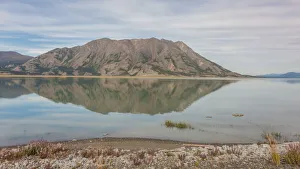 Canada, Yukon. Still water of Lake Kluane reflects Sheep Mountain on the Alaska Highway Canada, Yukon. Still water of Lake Kluane reflects Sheep Mountain on the Alaska Highway