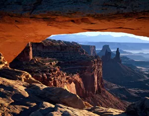 Eroded Gallery: CANYONLANDS NATIONAL PARK, UTAH. USA. View through Mesa Arch at sunrise. Island in the Sky