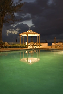 Caribbean Sea, Cayman Islands. A resort pool at night Caribbean Sea, Cayman Islands. A resort pool at night