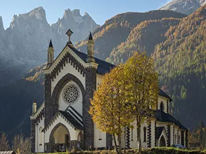 Chiesa di San Sebastiano in Falcade in Val Biois, in the background the Focobon mountain Chiesa di San Sebastiano in Falcade in Val Biois, in the background the Focobon mountain