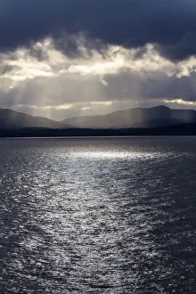 Chile, Patagonia, Strait of Magellan. Tierra del Fuego, rays of sunshine over the fjords Chile, Patagonia, Strait of Magellan. Tierra del Fuego, rays of sunshine over the fjords
