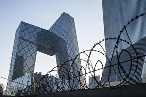 China, Beijing, Barbed wire surrounds perimeter of gleaming steel and glass CCTV China, Beijing, Barbed wire surrounds perimeter of gleaming steel and glass CCTV