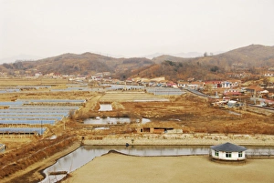 China, Dandong, elevated view of a salt pond with human settlement and mountains China, Dandong, elevated view of a salt pond with human settlement and mountains