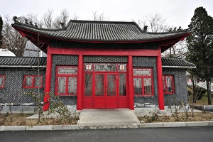 China, Dandong, roofed built structure with a red door and windows China, Dandong, roofed built structure with a red door and windows