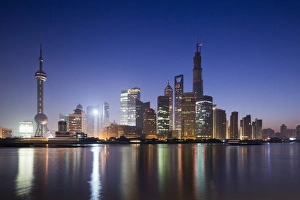 China, Shanghai, Glow of twilight behind towering skyline of Pudong district along China, Shanghai, Glow of twilight behind towering skyline of Pudong district along