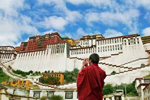 Images Dated 6th May 2011: China, Tibet, Lhasa, Tibetan monk with Potala Palace (MR)