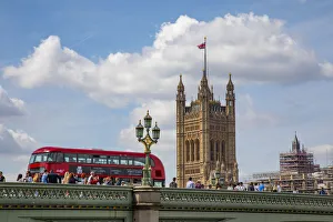 Classic double decker tour bus in London, England crossing the bridge River Thames with Classic double decker tour bus in London, England crossing the bridge River Thames with