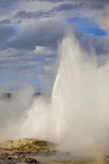 Clepsydra Geyser erupts in late afternoon light in the Lower Geyser Basin of Yellowstone Clepsydra Geyser erupts in late afternoon light in the Lower Geyser Basin of Yellowstone