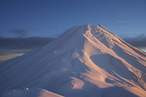 Climbers at Syme Hut, Fanthams Peak, and Alpenglow at Dawn on Mt Taranaki / Mt Egmont Climbers at Syme Hut, Fanthams Peak, and Alpenglow at Dawn on Mt Taranaki / Mt Egmont